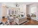 Cozy living room with fireplace, large windows, hardwood floors, and comfortable seating at 3280 Stillhouse Se Ln # 305, Atlanta, GA 30339