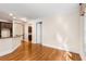 View of the hardwood floors in the living room, which features neutral walls and a pass-through to the kitchen at 3280 Stillhouse Se Ln # 305, Atlanta, GA 30339