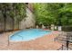 Outdoor pool with brick patio, surrounded by trees and featuring lounge chairs at 3280 Stillhouse Se Ln # 305, Atlanta, GA 30339