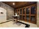The wine cellar features an arched entryway, stone accent walls, wood ceiling, and a wine storage unit at 3280 Stillhouse Se Ln # 305, Atlanta, GA 30339