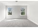 Bright bedroom with two large windows and carpet at 490 Paces Dr, Lithia Springs, GA 30122