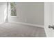 Well-lit bedroom featuring neutral walls and carpet at 490 Paces Dr, Lithia Springs, GA 30122