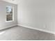Bright bedroom featuring grey carpet and large window at 490 Paces Dr, Lithia Springs, GA 30122
