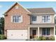 Two-story brick home with a beige second floor and a double-car garage at 490 Paces Dr, Lithia Springs, GA 30122