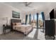 Spacious bedroom with plush carpet, balcony access, and a ceiling fan at 384 Ralph Mcgill Ne Blvd # 404, Atlanta, GA 30312
