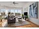 Living room with hardwood floors, large windows, and a gray sofa at 384 Ralph Mcgill Ne Blvd # 404, Atlanta, GA 30312