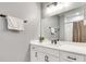 Modern bathroom with white vanity, large mirror, and a shower at 1072 Brookglynn Trce, Decatur, GA 30032