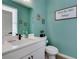 Modern bathroom with teal walls and white vanity at 1072 Brookglynn Trce, Decatur, GA 30032