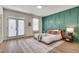 Bright bedroom with a queen bed, accent wall, and access to a private balcony at 1072 Brookglynn Trce, Decatur, GA 30032