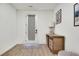 Minimalist entryway featuring a modern door and rustic wood dresser at 1072 Brookglynn Trce, Decatur, GA 30032