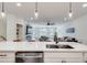 Modern kitchen leading to living space, featuring an island with a sink and stainless steel dishwasher at 1072 Brookglynn Trce, Decatur, GA 30032
