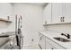 Bright laundry room with washer, dryer, and white cabinets at 1072 Brookglynn Trce, Decatur, GA 30032
