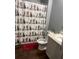 Bathroom features a novelty shower curtain with a toilet and vanity at 11547 Hathaway Dr, Hampton, GA 30228
