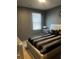 Well-lit bedroom features neutral walls, stylish furniture, and a comfortable bed with decorative pillows at 11547 Hathaway Dr, Hampton, GA 30228