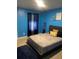 Bedroom features a bed with blue walls and carpeted floors at 11547 Hathaway Dr, Hampton, GA 30228