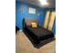 Bedroom with blue walls and dark bedding at 11547 Hathaway Dr, Hampton, GA 30228