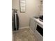 Laundry room with a stacked washer/dryer and Laundry Co. sign at 11547 Hathaway Dr, Hampton, GA 30228