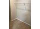 Empty walk-in closet features carpet and a white wire rack for storage at 11547 Hathaway Dr, Hampton, GA 30228