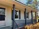 Covered porch with gray columns and railings at 582 Rebecca St, Lawrenceville, GA 30046