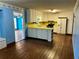 Kitchen with white cabinets, yellow countertops, and hardwood floors at 582 Rebecca St, Lawrenceville, GA 30046