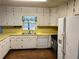 Kitchen with white cabinets and yellow countertops at 582 Rebecca St, Lawrenceville, GA 30046