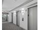 Modern building hallway with three elevators and carpeted floors at 1280 W Peachtree Nw St # 3306, Atlanta, GA 30309