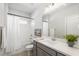 Bright bathroom with a shower/tub combo, subway tiles, modern vanity and a large mirror and lighting fixture at 396 Silverbell Way, Marietta, GA 30060