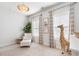 Bright Bedroom with ample natural light, decorative giraffe, rocker, and white walls at 396 Silverbell Way, Marietta, GA 30060
