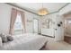 Bright bedroom features white walls, plush carpeting, chandelier, large window and a door to the ensuite at 396 Silverbell Way, Marietta, GA 30060