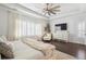 Bright bedroom boasts large windows, a ceiling fan, and a decorative TV console at 396 Silverbell Way, Marietta, GA 30060