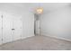 A large bedroom with neutral carpet and a double door closet is ready for furnishing at 396 Silverbell Way, Marietta, GA 30060