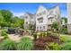 Beautiful two-story townhouse with a brick patio, fire pit, and outdoor seating surrounded by lush landscaping at 396 Silverbell Way, Marietta, GA 30060
