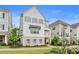 Inviting two-story townhouse features a brick patio and an outdoor fire pit area with landscaped yard and walkway at 396 Silverbell Way, Marietta, GA 30060