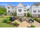 Attractive two-story townhouse with a brick patio, fire pit, and lounge seating surrounded by manicured landscaping at 396 Silverbell Way, Marietta, GA 30060