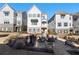 Exterior of townhomes featuring a landscaped fire pit area, perfect for outdoor gatherings and relaxation at 396 Silverbell Way, Marietta, GA 30060