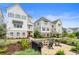 Charming two-story townhouse with a brick patio, fire pit, and cozy seating area in a beautifully landscaped yard at 396 Silverbell Way, Marietta, GA 30060