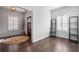 Bright foyer features hardwood floors, a stylish rug, and natural light from window with plantation shutters at 396 Silverbell Way, Marietta, GA 30060