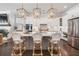 Well-appointed kitchen with island, pendant lights, stainless appliances, and seamless flow to living area at 396 Silverbell Way, Marietta, GA 30060