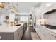 Modern kitchen flows into the living space and provides stone countertops and an island with seating at 396 Silverbell Way, Marietta, GA 30060