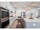 The sleek kitchen boasts stone countertops, stainless steel appliances, and a convenient center island at 396 Silverbell Way, Marietta, GA 30060