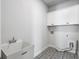 Functional laundry room with gray patterned floors and white cabinets at 396 Silverbell Way, Marietta, GA 30060