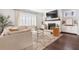 Bright living room features a cozy couch, fireplace with mantel, and large windows at 396 Silverbell Way, Marietta, GA 30060
