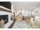 Open layout of living room to kitchen, featuring modern decor, fireplace and island at 396 Silverbell Way, Marietta, GA 30060