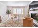 Sunlit living room showcases a comfortable couch, fireplace with mantel, and stylish decor at 396 Silverbell Way, Marietta, GA 30060