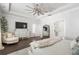 Bright main bedroom with a tray ceiling, ceiling fan, fireplace, sitting area, and ensuite bathroom at 396 Silverbell Way, Marietta, GA 30060