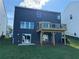 Backyard with a small grass lawn, a second-story deck, and a sliding glass door to enter the home at 110 Okeechobee Way, Braselton, GA 30548