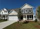 Charming two-story home with a well-manicured lawn and an attached two-car garage at 110 Okeechobee Way, Braselton, GA 30548