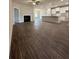 Open living space featuring hardwood floors, fireplace, and open kitchen layout at 11200 Cornerstone Way, Lovejoy, GA 30228