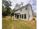 House backyard features a covered patio and fenced-in grassy area at 1679 Eastside Parc St, Atlanta, GA 30316