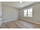Bright bedroom featuring hardwood floors and a large window at 1679 Eastside Parc St, Atlanta, GA 30316